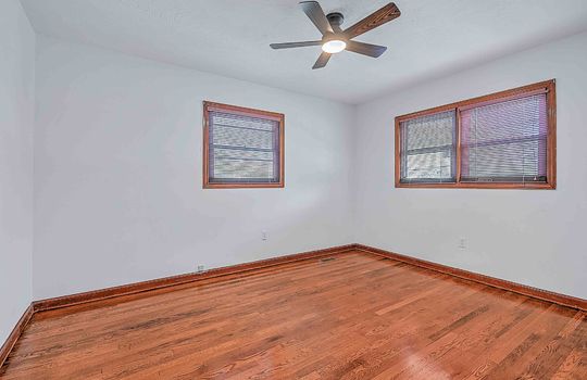 bedroom, hardwood flooring, windows, ceiling fan