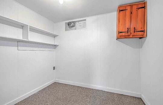 Utility room, carpet, painted paneling wall, cabinet