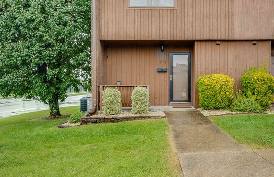 townhouse, front porch, storm door, front door, wood siding, concrete exterior, window, landscaping