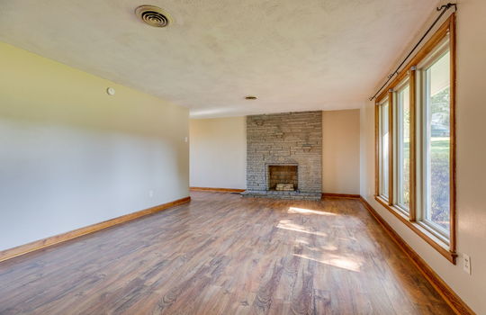 living room, fireplace, large windows, laminate flooring