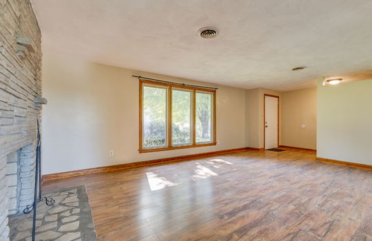 living room, front door, fireplace, windows