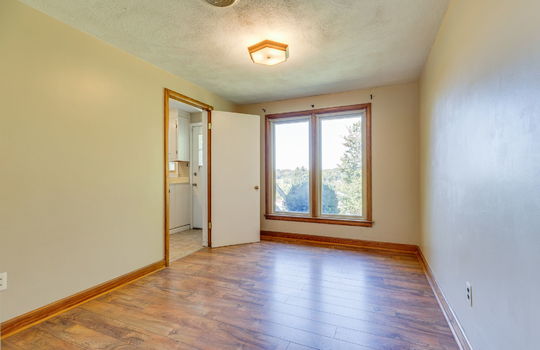dining room, laminate flooring, window, door to kitchen