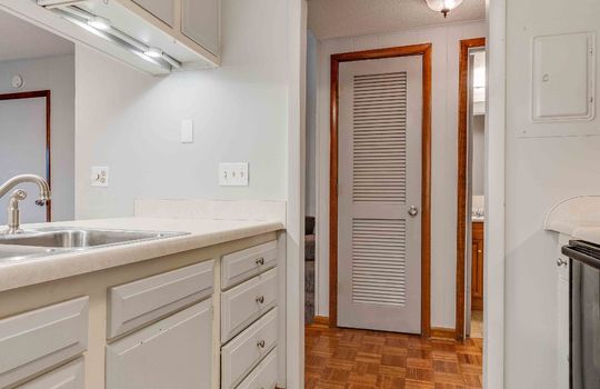 kitchen, sink, cabinets, countertops door to hallway