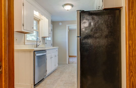 kitchen, refrigerator, dishwasher, tile flooring, sink, countertops, cabinets