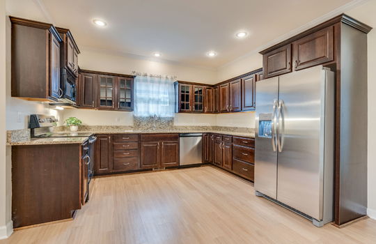 kitchen, hardwood flooring, cabinets, granite countertops, stainless appliances, refrigerator, dishwasher, oven/range, built-in microwave, sink, window above sink