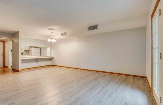 living room, door to patio, dining area, bar seating, kitchen