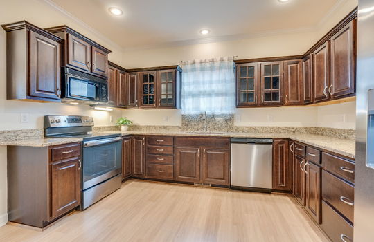 kitchen, hardwood flooring, cabinets, granite countertops, stainless appliances, refrigerator, dishwasher, oven/range, built-in microwave, sink, window above sink