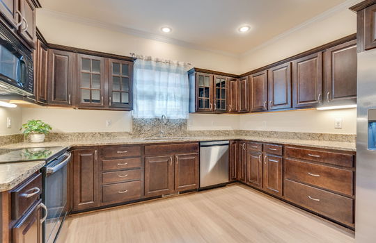 kitchen, hardwood flooring, cabinets, granite countertops, stainless appliances, refrigerator, dishwasher, oven/range, built-in microwave, sink, window above sink