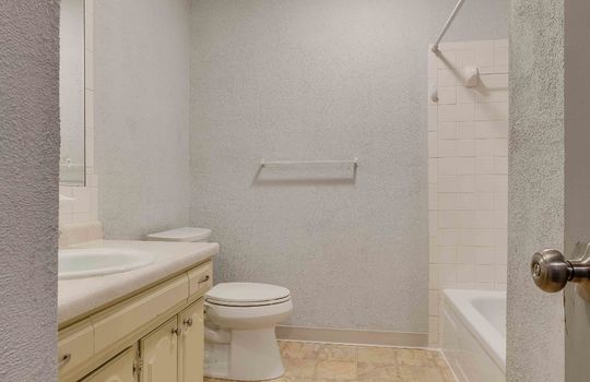 bathroom, vinyl flooring, tub/shower, toilet, sink