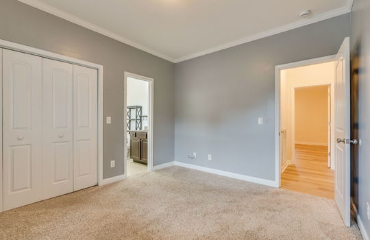 bedroom, carpet, bathroom, closet, hallway door