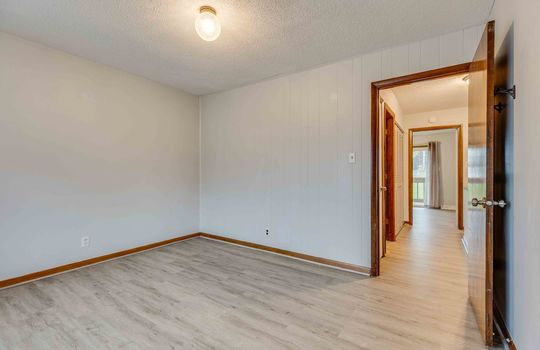 bedroom, vinyl flooring, door to hallway