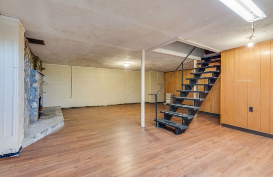 lower level, living room, stairs, paneling walls, laminate flooring