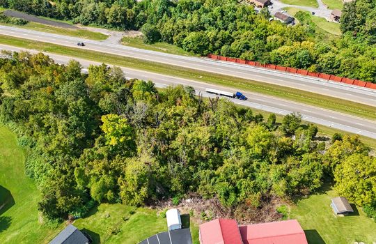 aerial view of property, nearby interstate, nearby properties, wooded property