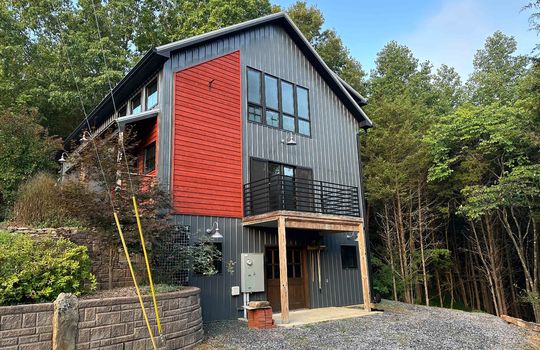 guest home exterior, metal siding, deck, patio, landscaping, gravel driveway