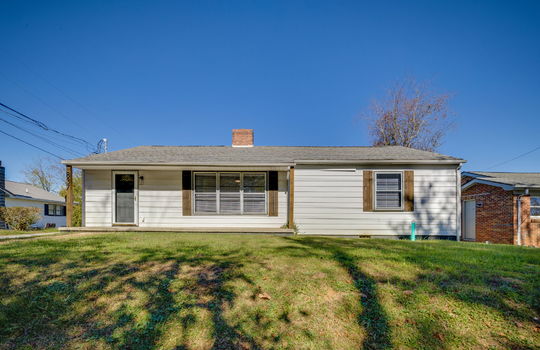 ranch style home, front porch, front door, storm door, vinyl siding, sidewalk, front yard