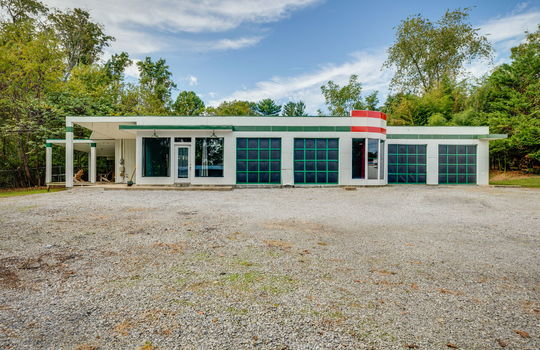 residential home for lease, gravel driveway, contemporary home, yard, trees