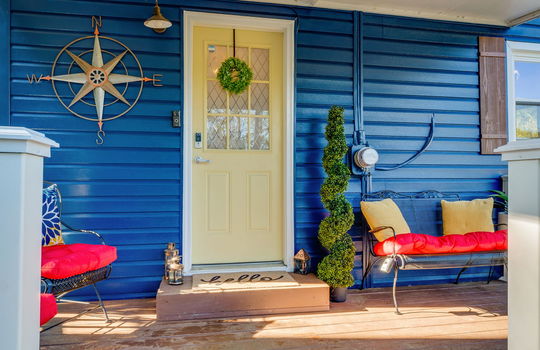 covered front porch, vinyl siding, front door