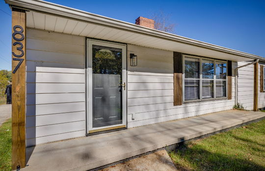 Front porch, ranch style home, front door, vinyl siding, storm door