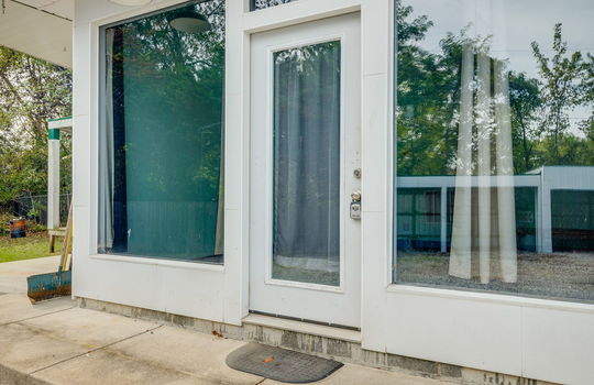 front door, window surrounds, concrete porch