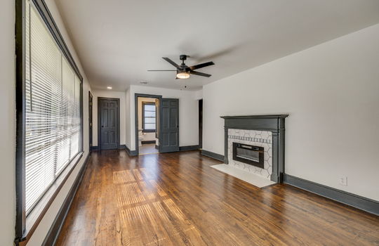 living room, fireplace, hardwood flooring, ceiling fan, window, front door, closet, bathroom door