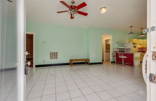 kitchen, tile flooring, bar seating, metal cabinets, ceiling fan