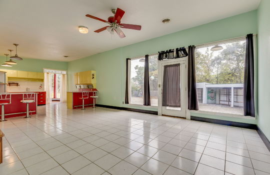 kitchen, diner style seating, bar seating, metal cabinets, windows, tile flooring, ceiling fan