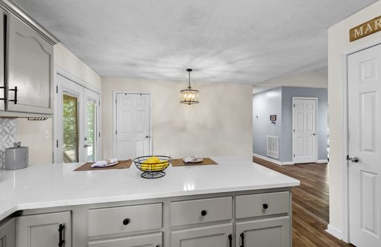 kitchen, bar seating area, pantry, dining area, door to back deck, open to living room
