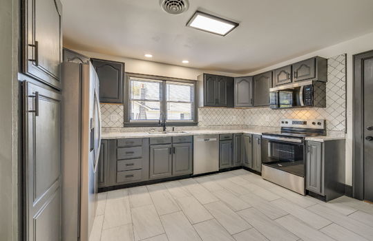 kitchen, tile flooring, tile backsplash, stainless steel appliances, refrigerator, oven/range, dishwasher, sink, cabinets, window above sink