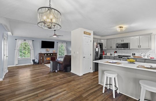 open floorplan, living room, dining area, bar seating, kitchen, pantry