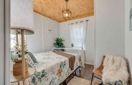 bedroom, beadboard ceiling, windows, luxury vinyl flooring