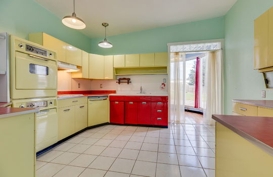 diner style kitchen, yellow and red metal cabinets, wall ovens, dishwasher, tile flooring