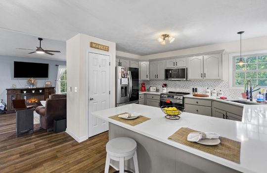 open floorplan, living room, dining area, bar seating, kitchen, pantry, luxury vinyl flooring