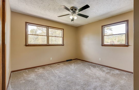 bedroom, carpet, wood trim, ceiling fan, closet