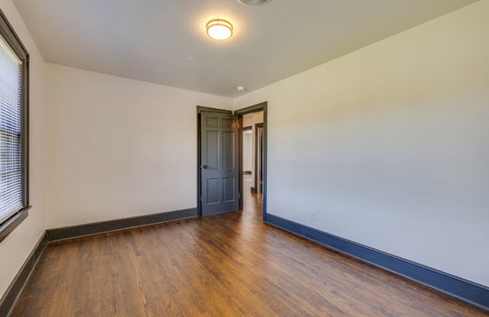 bedroom, hardwood flooring, closet, door to hallway, window