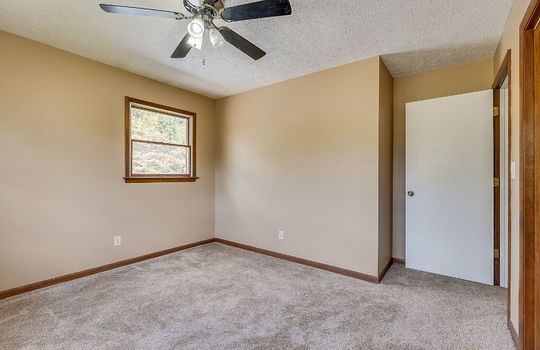 bedroom, ceiling fan, carpet, wood trim, windows, closet