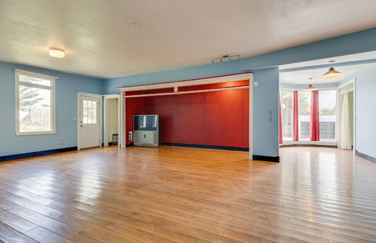 living room, open layout, laminate flooring, front door, windows, bay windows, dining area