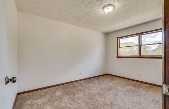 bedroom, wood trim, carpet, windows