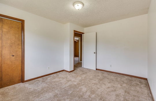 bedroom, carpet, wood trim, windows, closet