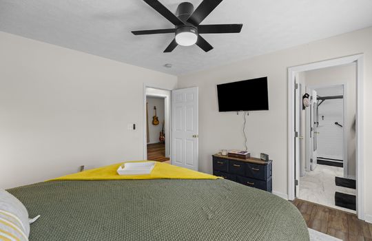 living room, primary bedroom, laminate flooring, ceiling fan, door to primary ensuite