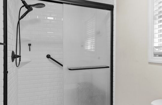 primary bathroom, shower, toilet, tile flooring