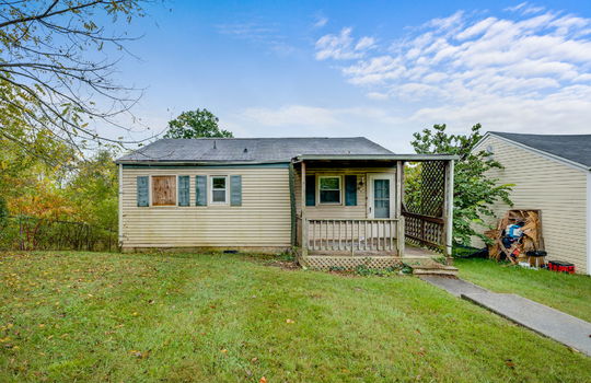 back of home, back yard, vinyl siding, bungalow, missing window, covered back porch, fixer upper, trees, neighboring home, sidewalk