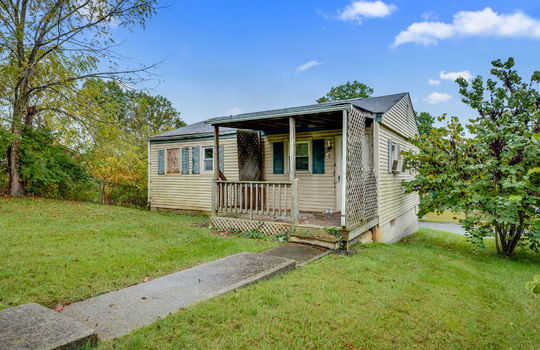 back of home, back yard, vinyl siding, bungalow, missing window, covered back porch, fixer upper, trees, neighboring home, sidewalk
