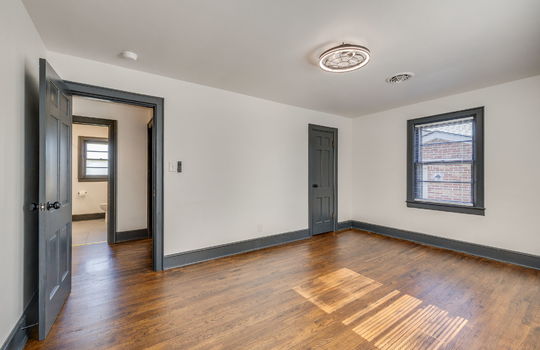 bedroom, hardwood flooring, closet, windows, door to hallway