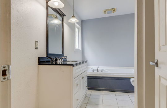 primary bedroom, ensuite bathroom, tile flooring, toilet, shower, tub, sink, windows