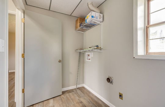 lower level laundry space, washer/dryer hookups, window, shelving