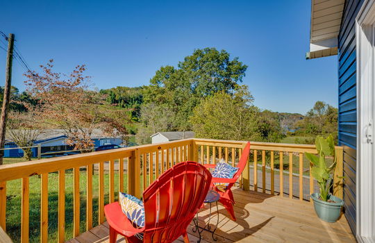 back deck overlooking back yard, wooden deck, vinyl siding, mountain views, neighboring homes