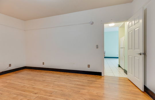 bedroom, laminate flooring, interior door to kitchen