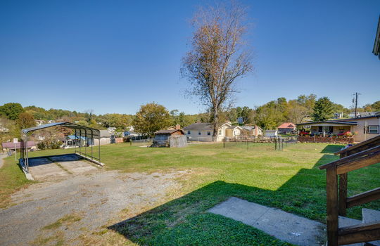 driveway, yard, carport, neighboring homes