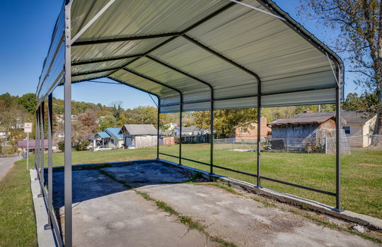 carport, driveway, yard, neighboring homes