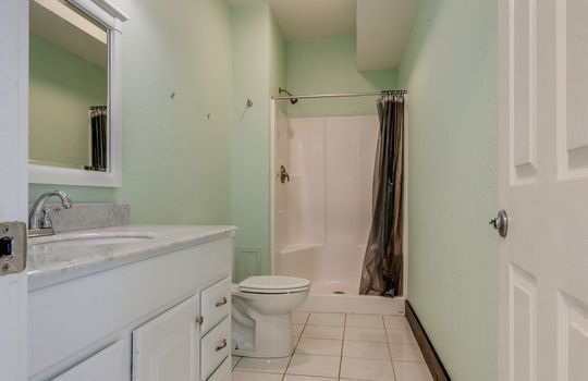 bathroom, shower, toilet, sink, tile flooring
